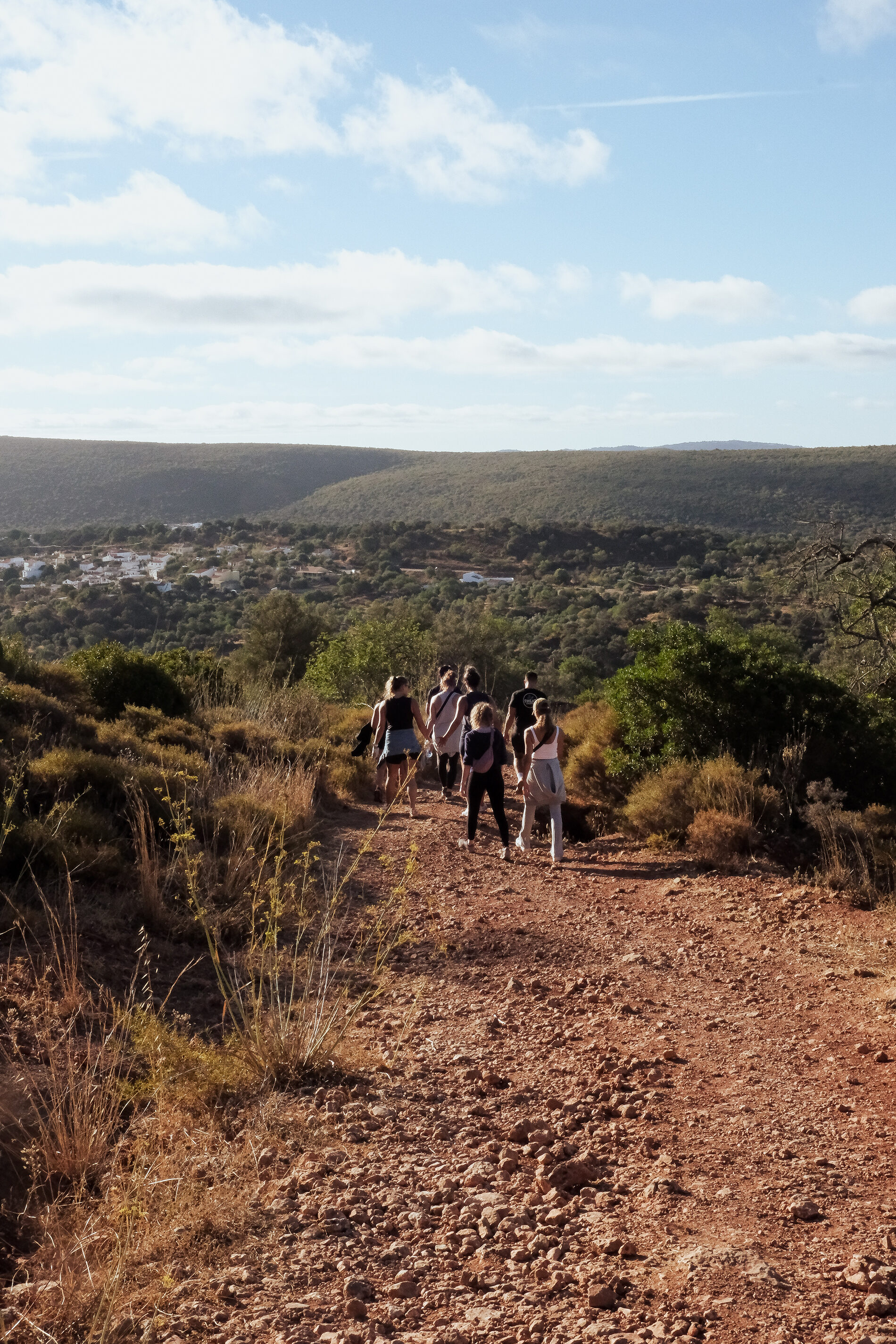 Guests on a coastal hike with sweeping Algarve views